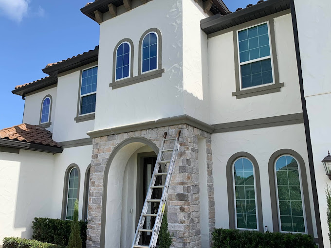 house exterior painted white with brown trim by certapro painters of east orlando