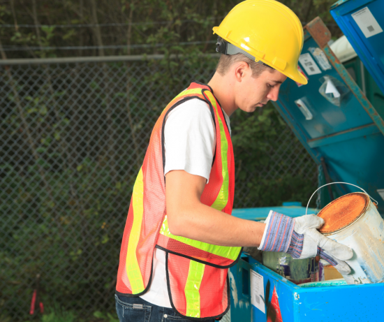 individual in the process of paint recycling