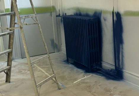 radiators being painted dark blue
