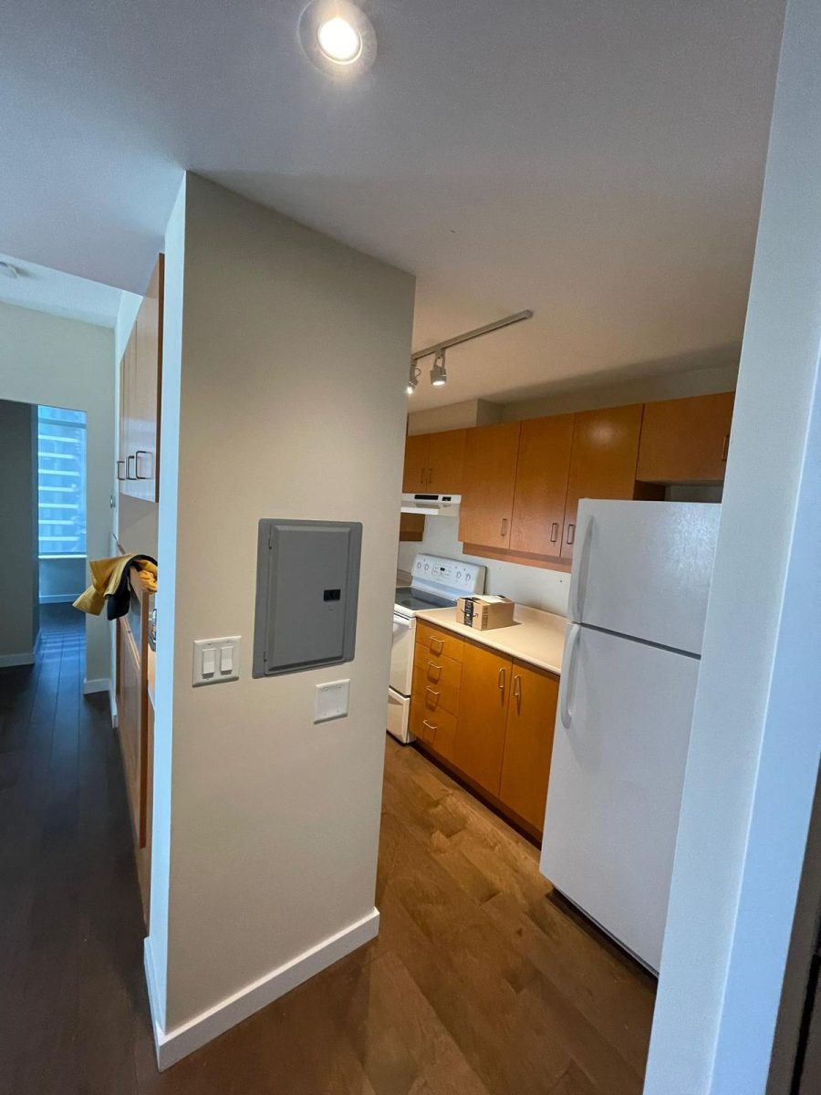view of apartment kitchen with unpainted wooden cabinets Preview Image 4