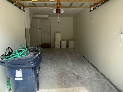 residential garage with garbage tote