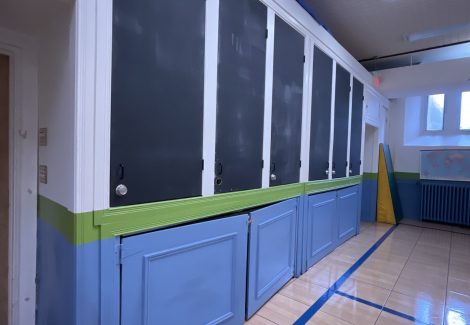 cabinets along school gymnasium wall with faded paint