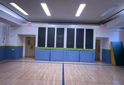 wall of cabinets with chalkboard doors in school gym