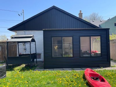 side of house with painted brick and siding