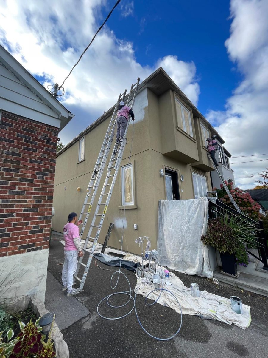 painters on ladder against stucco home during repaint Preview Image 4