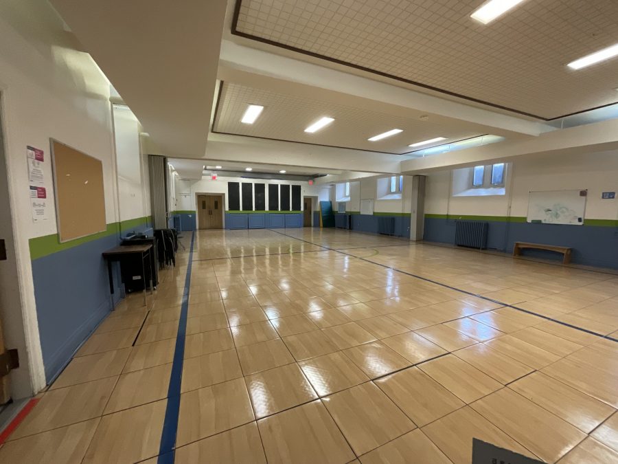chairs stacked along a wall in a school gymnasium Preview Image 15