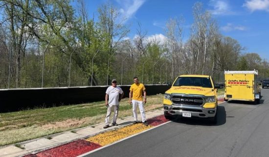 CertaPro painting the two metal crash walls at Road America