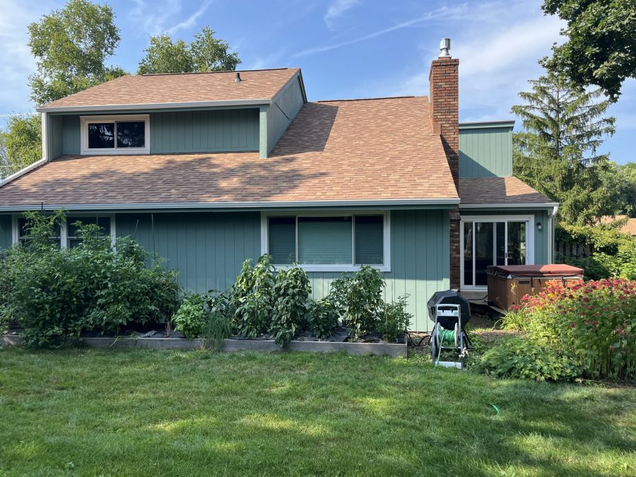 house with light green stained wooden siding