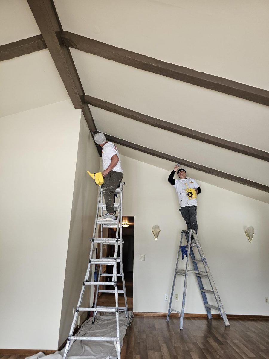 two people on ladders painting ceiling and exposed beams Preview Image 1