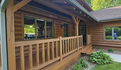 stained log home and front porch