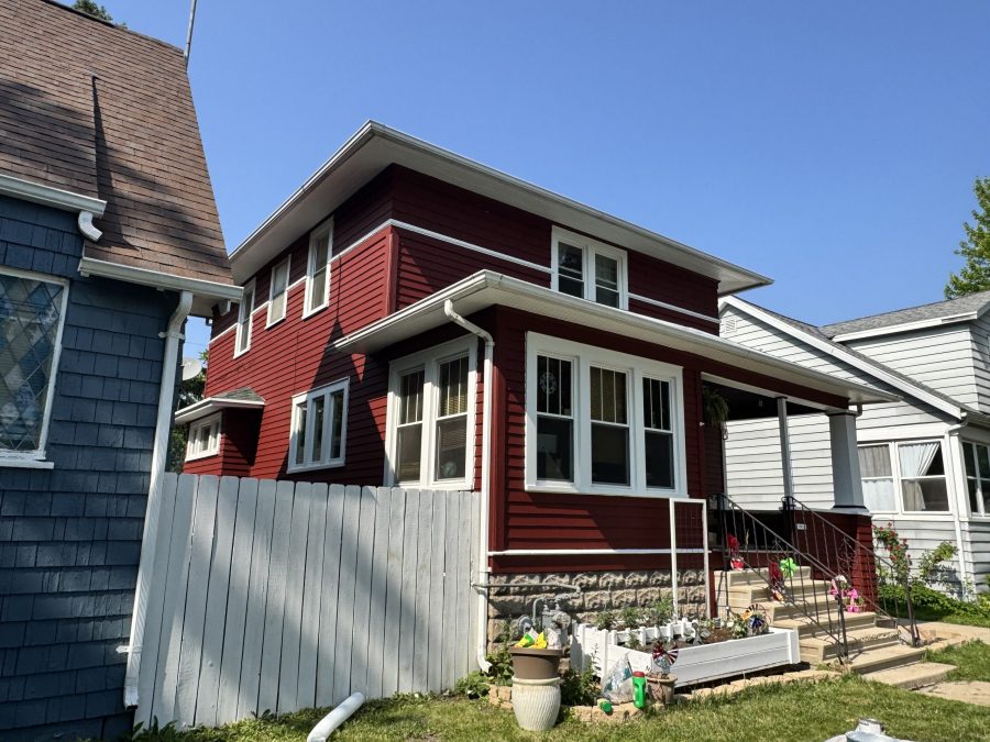 street view of home with dark red painted wood siding and white trim Preview Image 1