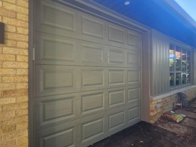 green painted garage and siding