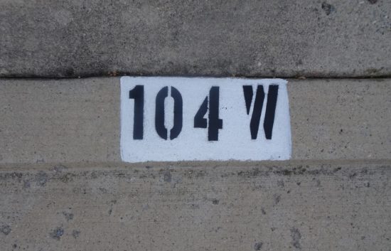 house number painted on curb