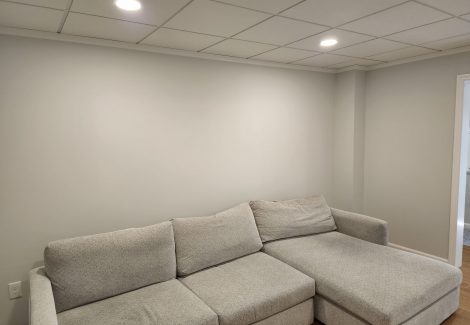 Walls painted to match an acoustic tile ceiling.