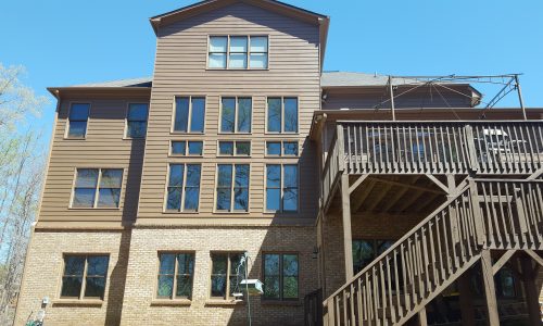 Home with brown exterior and wooden exterior stairs