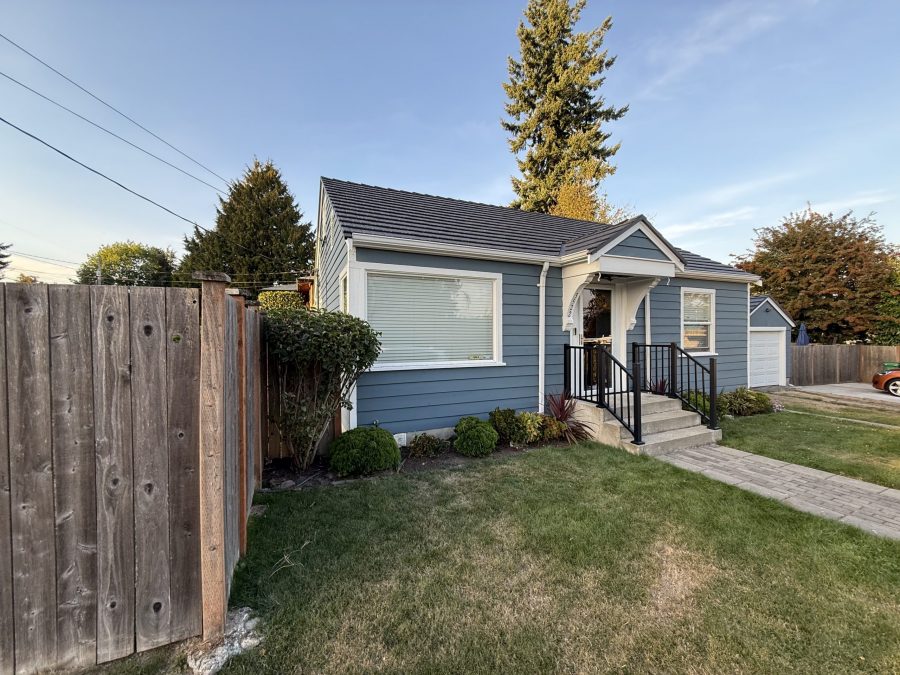 house and detached garage with repainted cedar siding