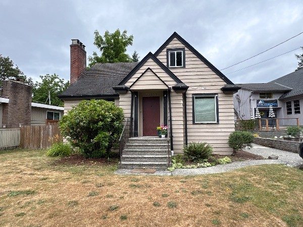 house with worn beige siding and dark trim Preview Image 2