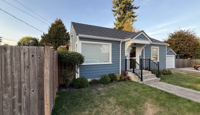 house and detached garage with repainted cedar siding