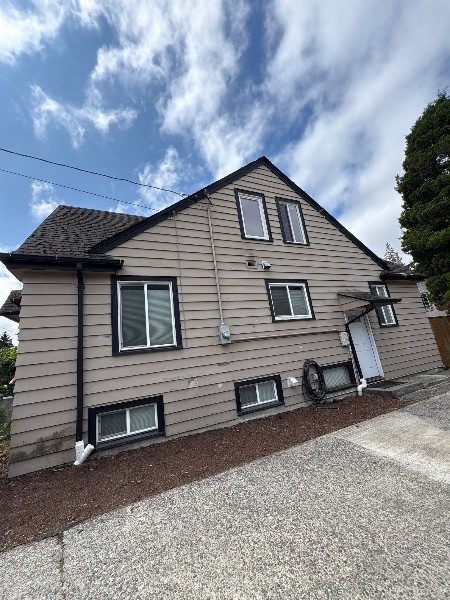 house with worn beige siding and dark trim Preview Image 3