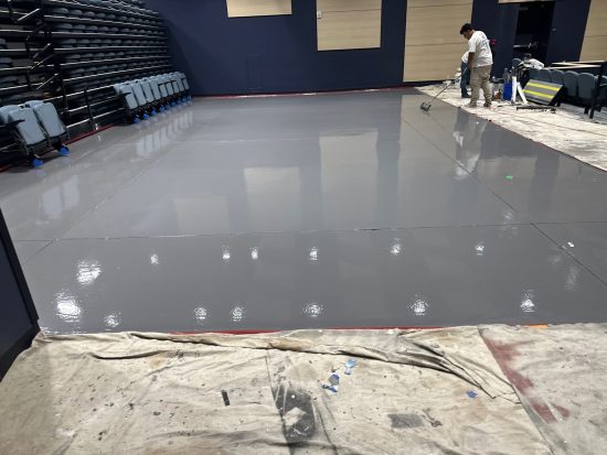 floor coating specialist working on epoxy floor