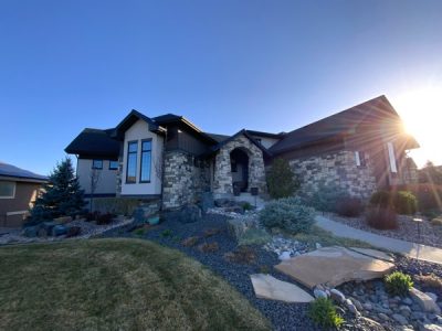 front corner view of house with stone and stucco siding