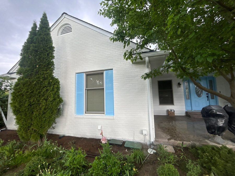 white painted brick home with blue shutters Preview Image 2