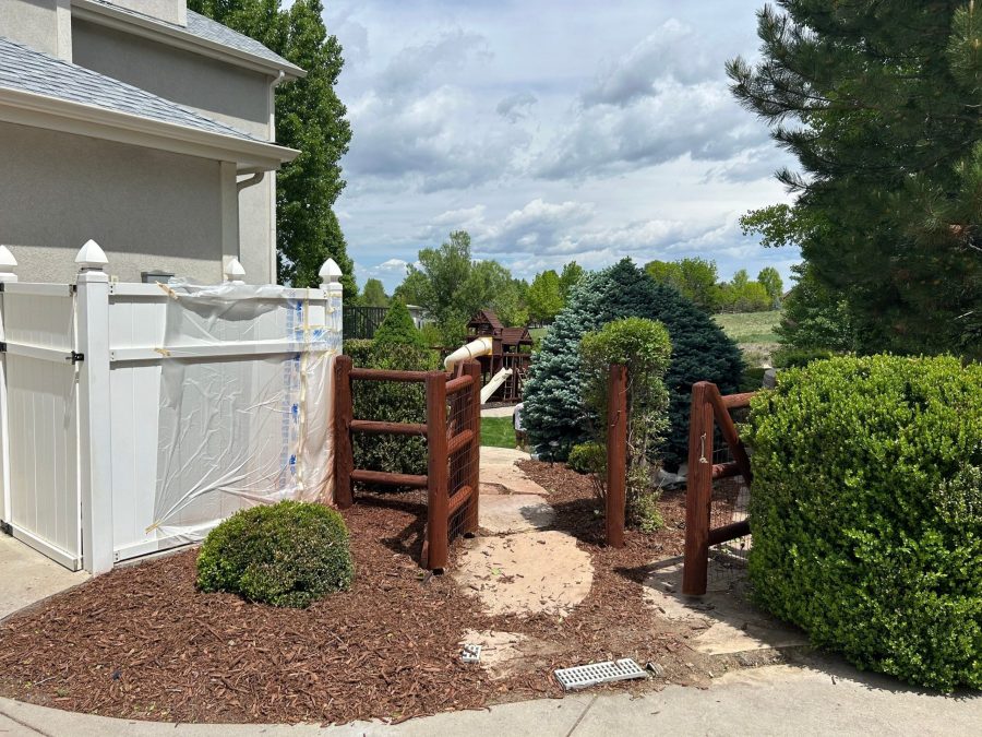 side of stucco house and stained wooden fence Preview Image 2