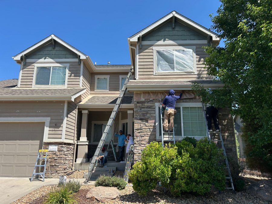 painters with ladders against house Preview Image 3