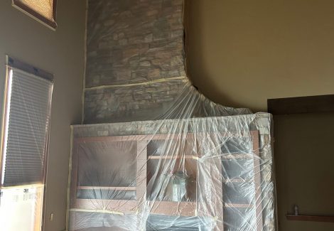 home fireplace with protective plastic during repaint