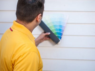 Color Consultant displaying paint colors on home exterior