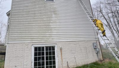 home with white siding before power washing