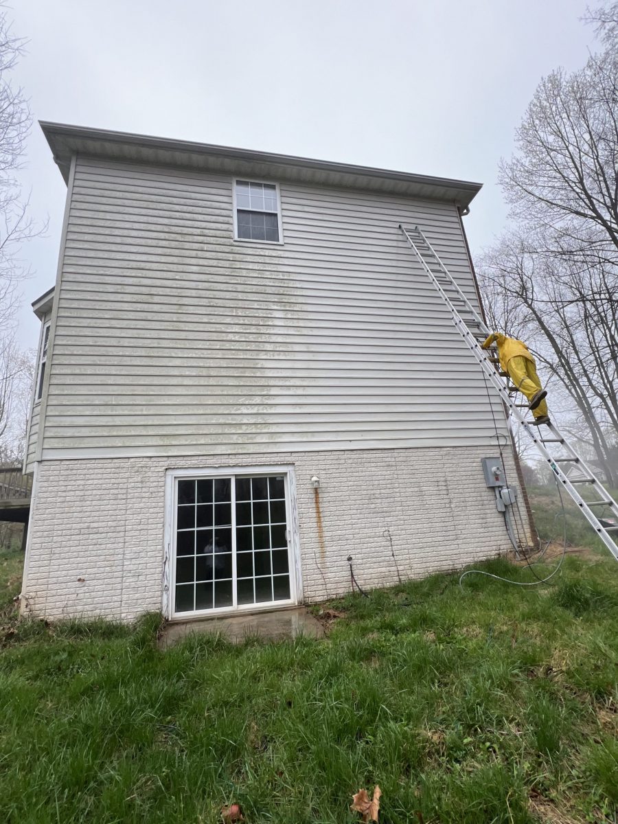 home with white siding before power washing