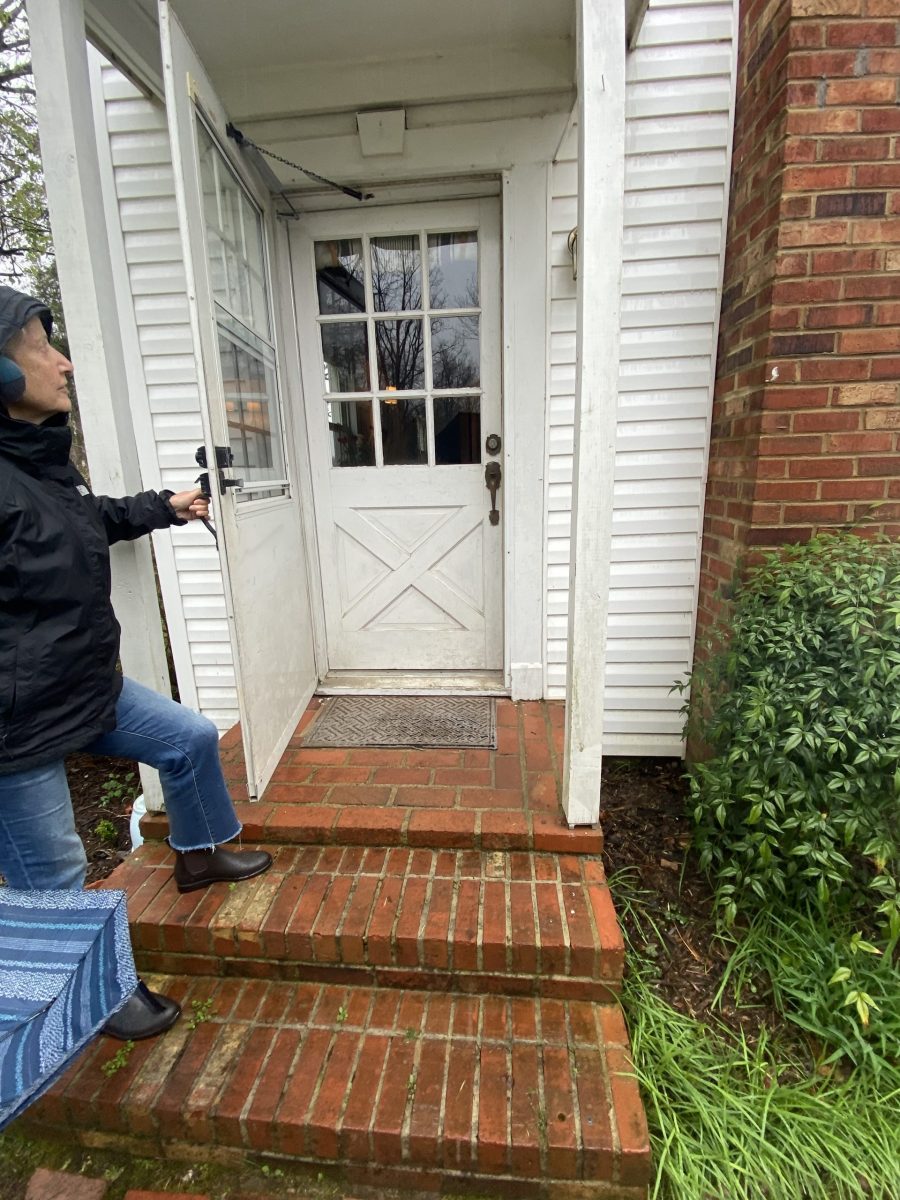 home with white siding door damage before