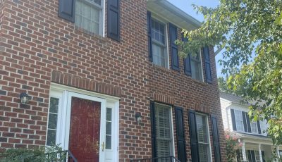 red front door on brick house