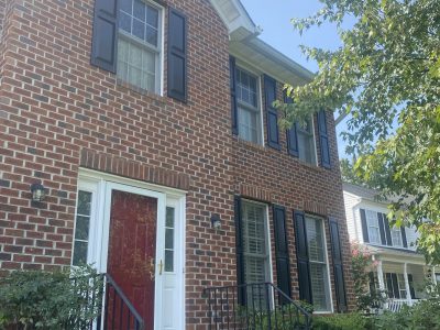 red front door on brick house