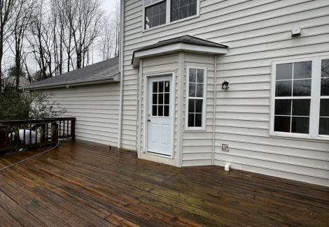 home with white siding before painting