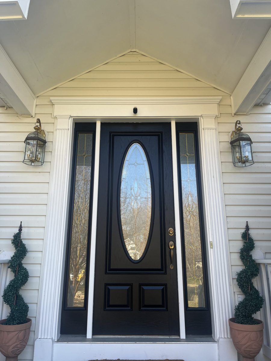 black painted front door of home with white siding Preview Image 1
