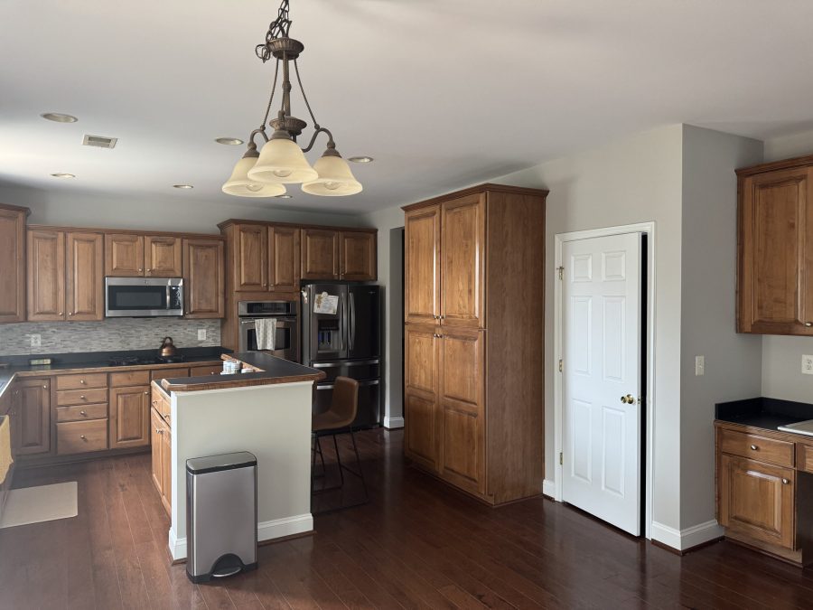 kitchen with wooden cabinets and painted walls Preview Image 2