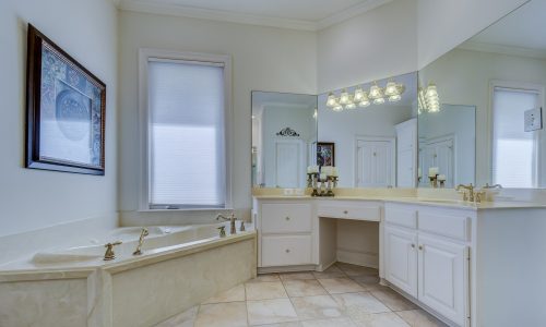 Bathroom with white painted cabinets
