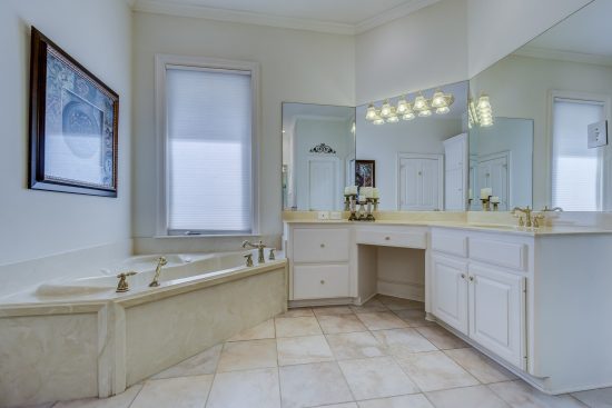 Bathroom with white painted cabinets