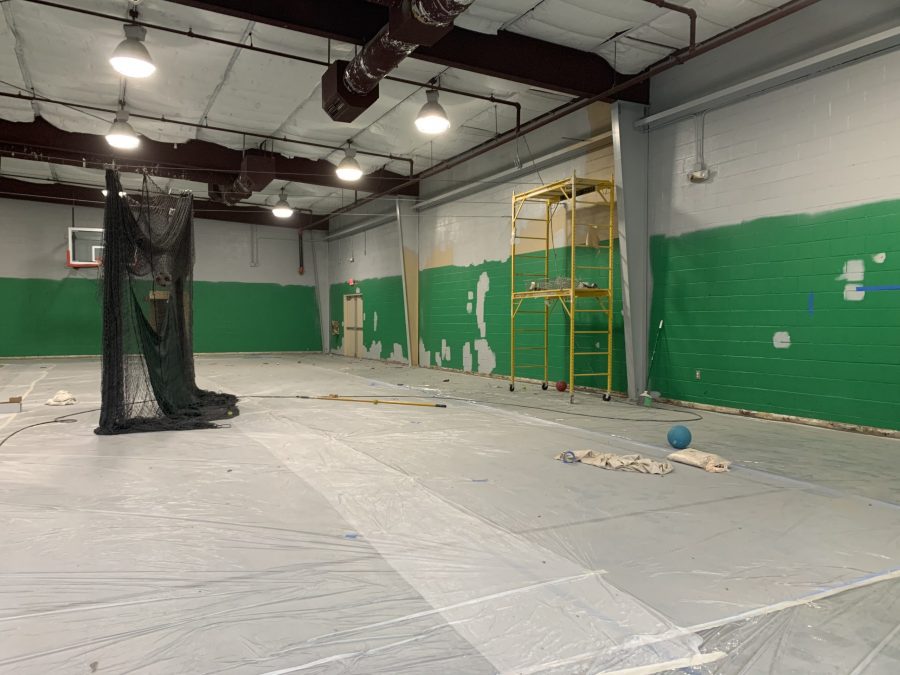 yellow and green painted walls of the Collierville gym interior being primed for repainting Preview Image 5