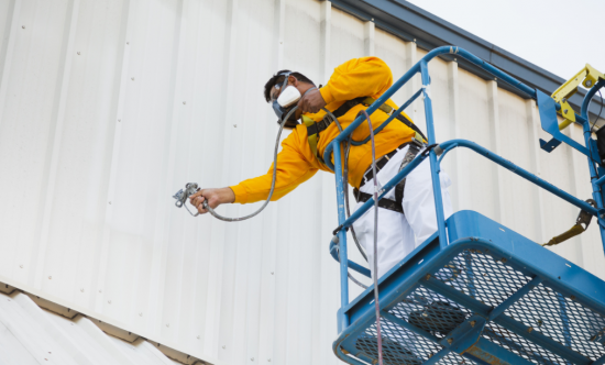 commercial painter using a lift in northwest arkansas