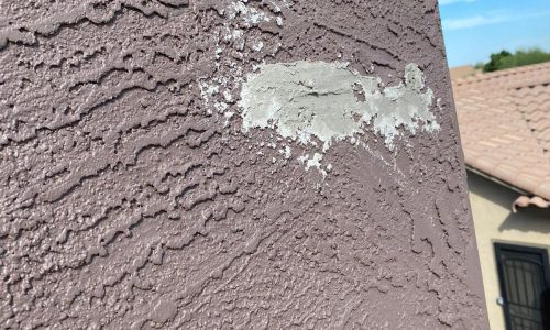 The stucco was patched in places as needed.