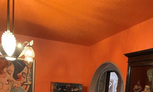 orange dining room with unique decor