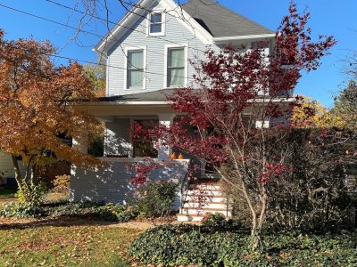 Historical grey home in fall weather