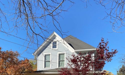 Historical grey home in fall weather