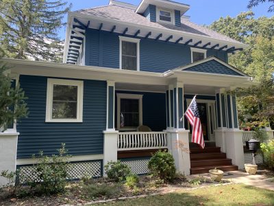an after photo of a house that was freshly painted blue on the exterior