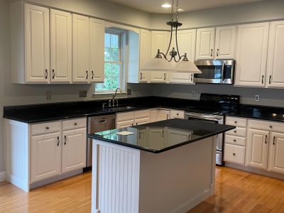 white kitchen cabinets with black countertops
