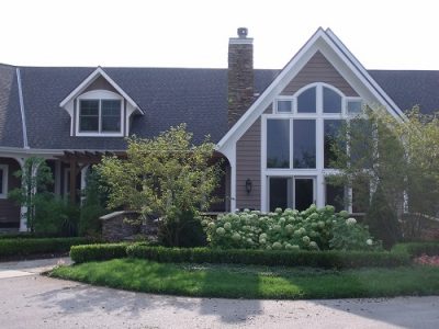 Exterior house painting by CertaPro painters in Ada, MI