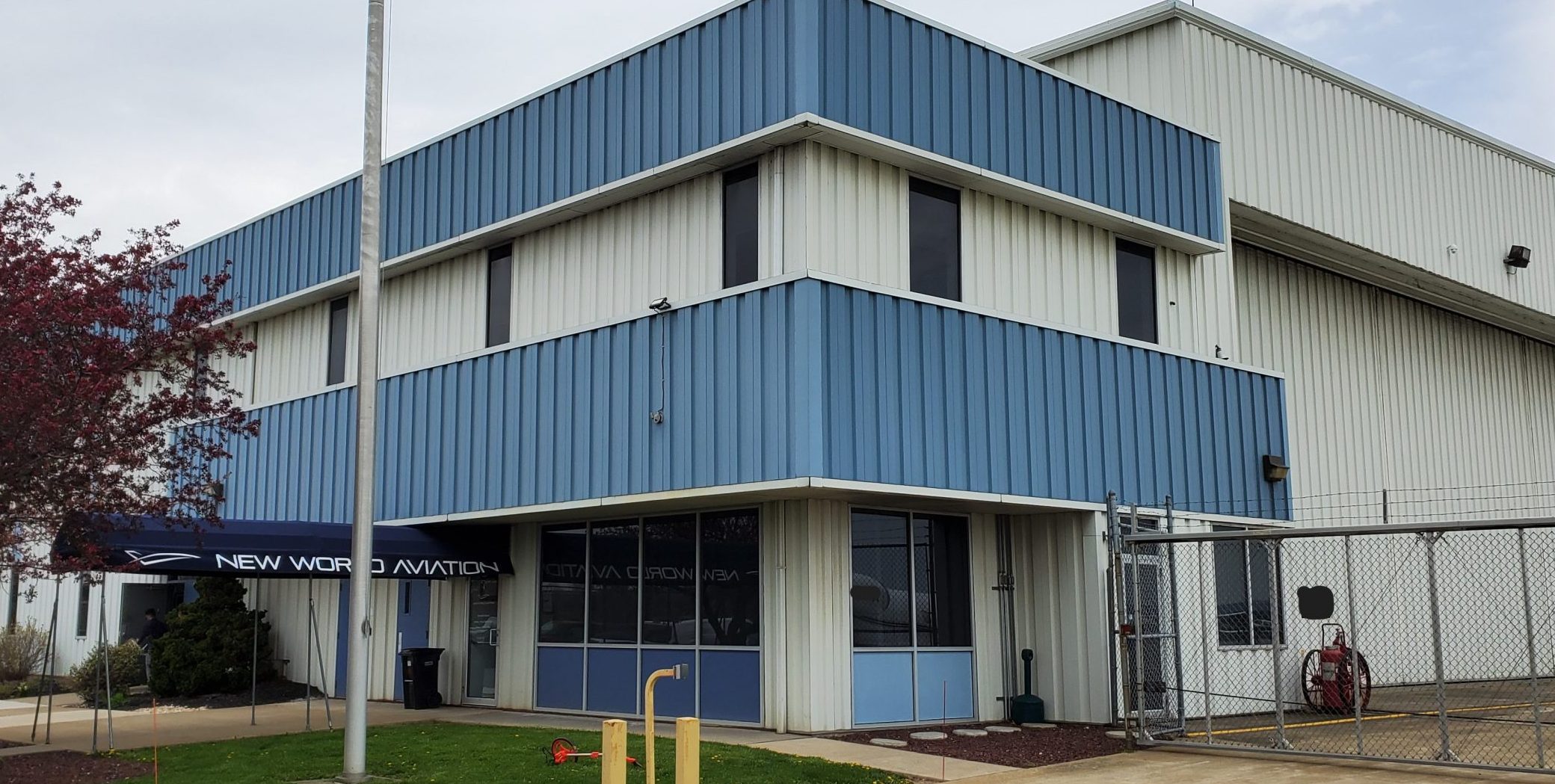 Front Corner Angle of New World Aviation in Allentown, PA, before commercial exterior painting project by CertaPro Painters of the Greater Lehigh Valley - Angle 2